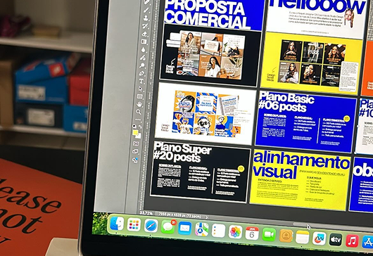 Graphic design layouts open on a desktop workspace
