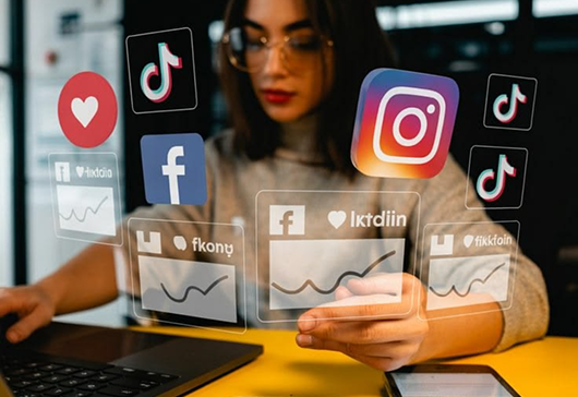 Social platform icons floating around a phone in use